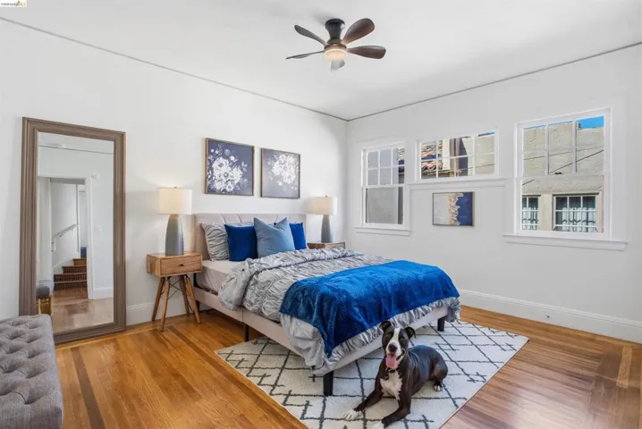 Bedroom with light wood finished floors and a ceiling fan