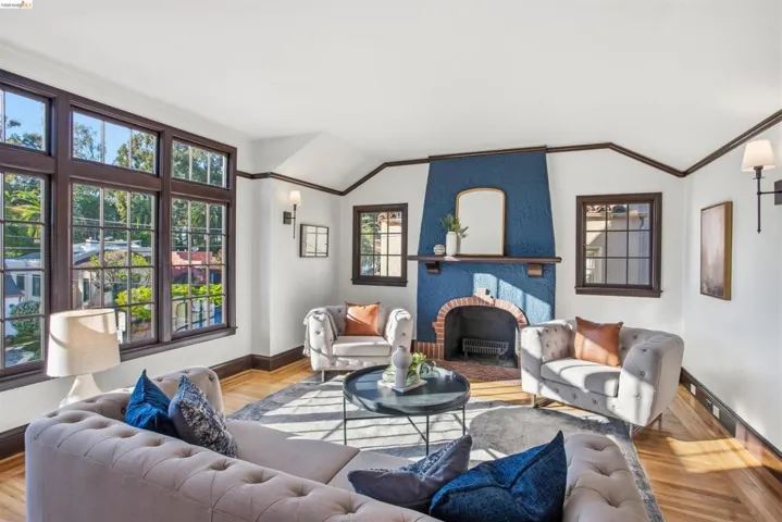 Living area with light wood-type flooring, a fireplace, and vaulted ceiling