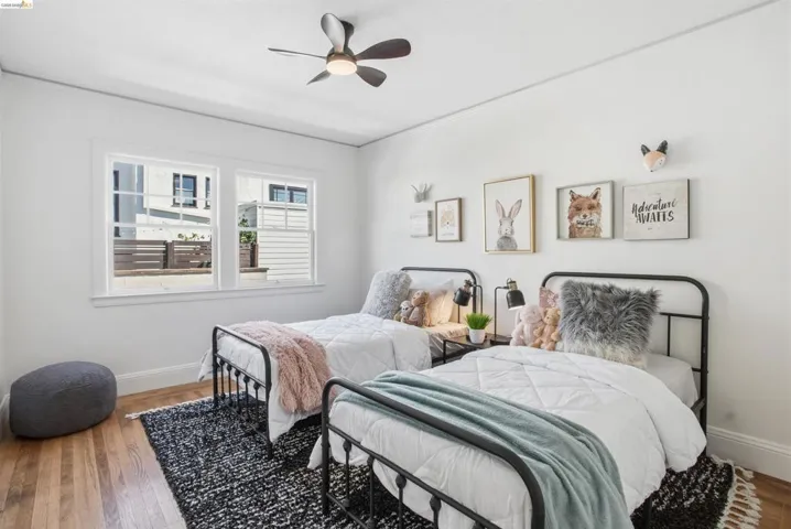 Bedroom featuring wood finished floors, crown molding, and ceiling fan