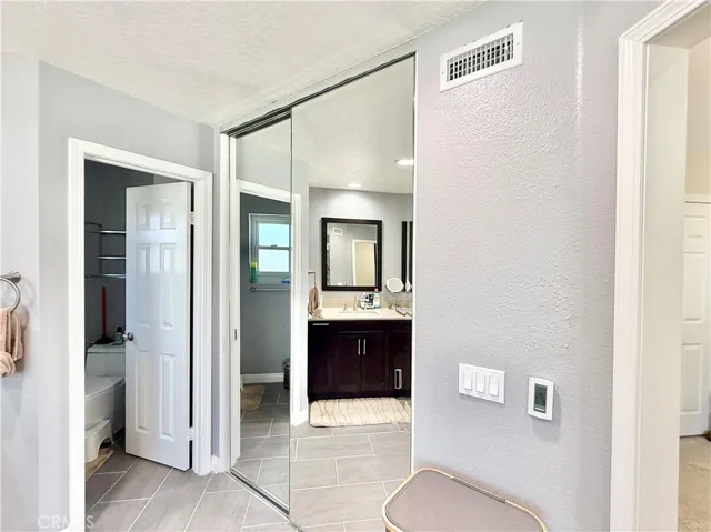 Primary bath walk-in closet and private toilet