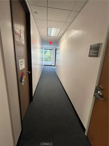 hallway leading to stairway that leads to  back entry.