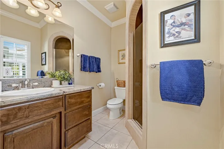 Third full bathroom with walk in shower, custom cabinetry & natural sky light