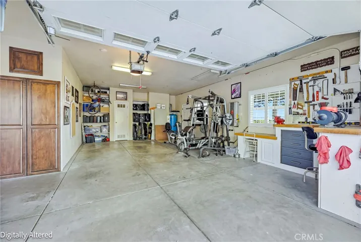 Single garage door with built in shelving and space for gym and workbench