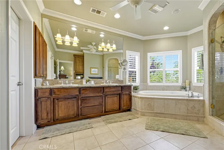 Master jetted tub with large walk in shower with three shower heads