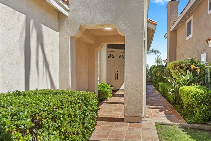 Tiled entry walk to double door front entry.