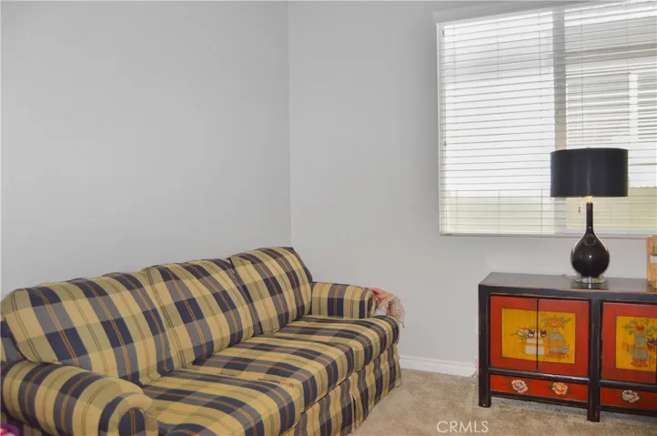 Den/office/possible 3rd bedroom with double-door entry, white blinds, cozy carpet, and pre-wired for overhead light