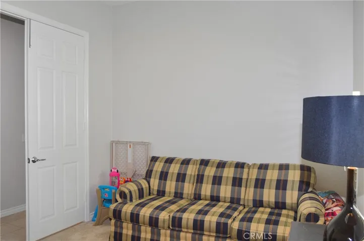 Den/office/possible 3rd bedroom with double-door entry, white blinds, cozy carpet, and pre-wired for overhead light