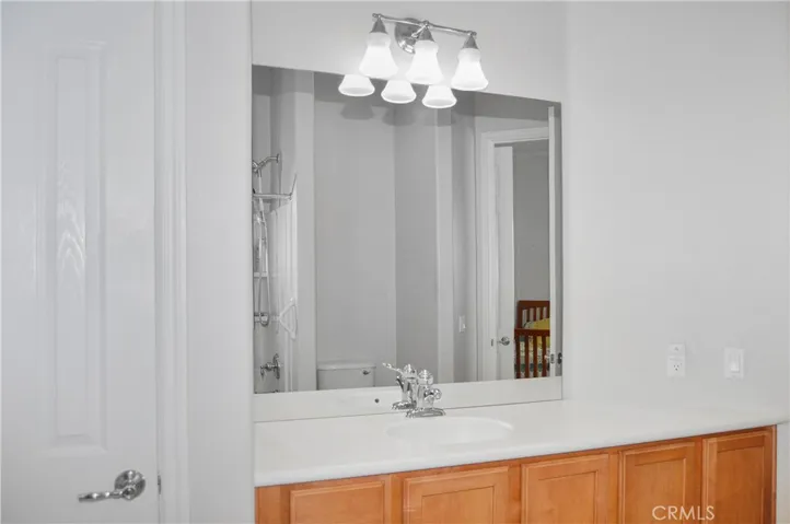 2nd bath - accessed from 2nd bedroom or hallway offers extra-tall dual shower heads in the shower/tub combo, handy linen closet, oversized white Corian-style vanity, and tile flooring