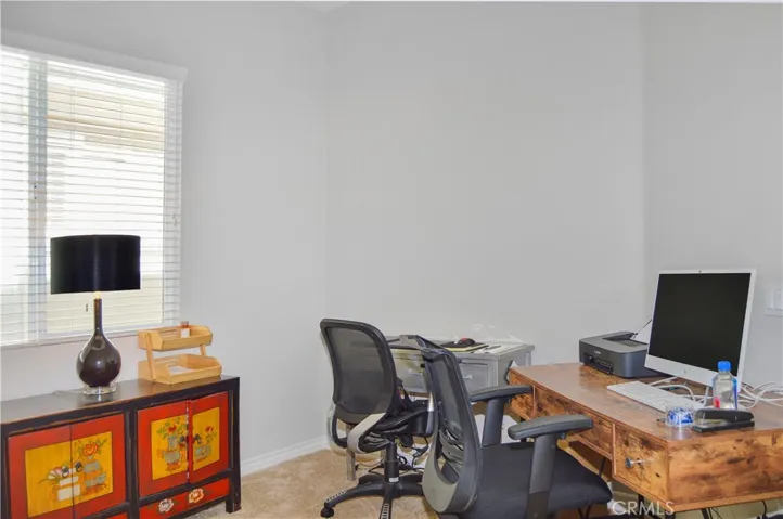 Den/office/possible 3rd bedroom with double-door entry, white blinds, cozy carpet, and pre-wired for overhead light