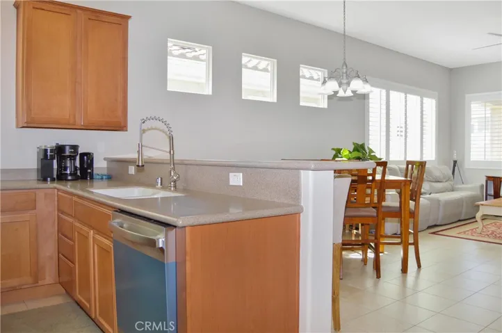 Well-equipped kitchen with BRAND NEW appliances in 2026 (Refrigerator, range, microwave & dishwasher), new faucet, louvered shutters, and Corian-style seamless countertops and back splash