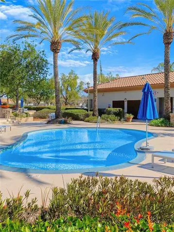 Relax and enjoy the sun at this resort-style outdoor pool area with two pools, a spa, and lush greenery surrounding you