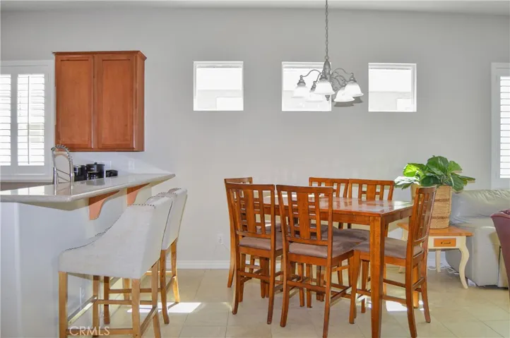 Dining area of the great room with breakfast counter is perfect for chatting with the chef