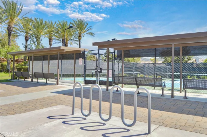 Pickleball courts with covered viewing areas and bike racks outside