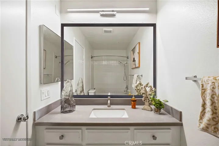 Updated bathroom with new LED light fixture and matching quartz/granite counter
