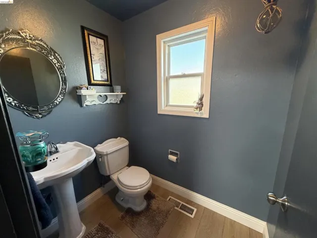 Bathroom with wood finished floors and a textured wall