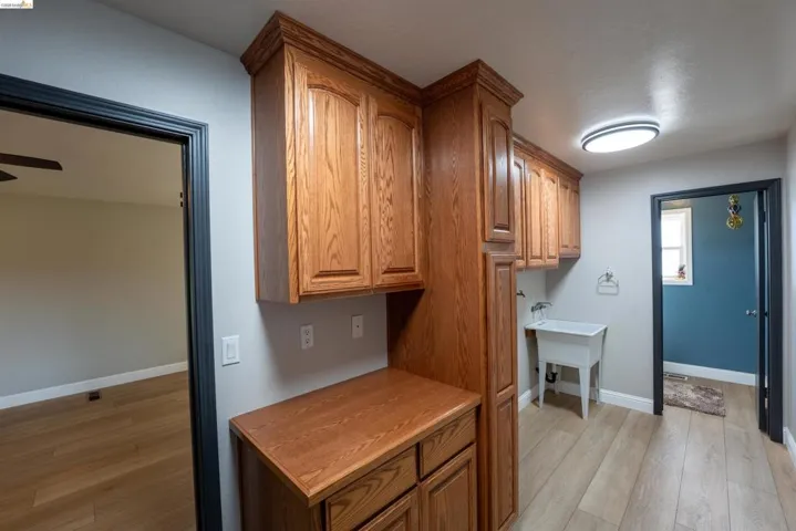Kitchen with light wood-style flooring and wood finish cabinets