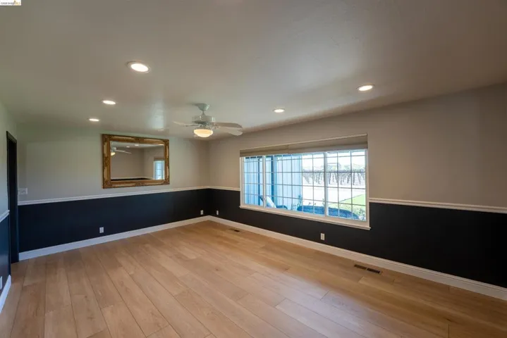 Spare room featuring recessed lighting, light wood finished floors, a ceiling fan, and wainscoting