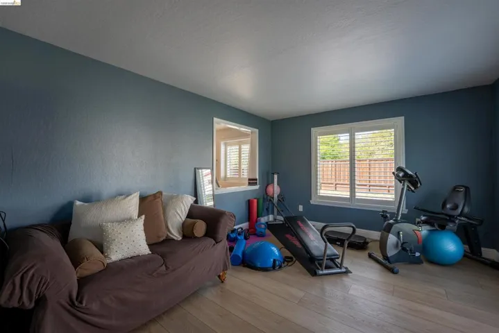 Workout area featuring wood finished floors and baseboards