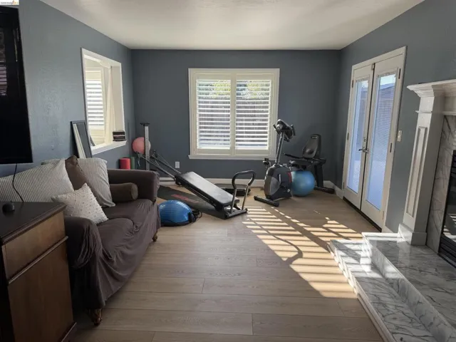 Exercise area featuring light wood-style flooring and healthy amount of natural light