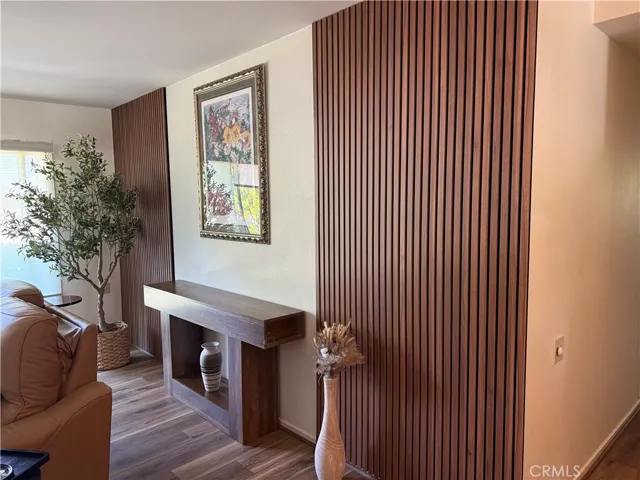 Custom vertical wood slat accent wall creates a warm, modern focal point, adding depth, texture, and architectural interest to the living space.