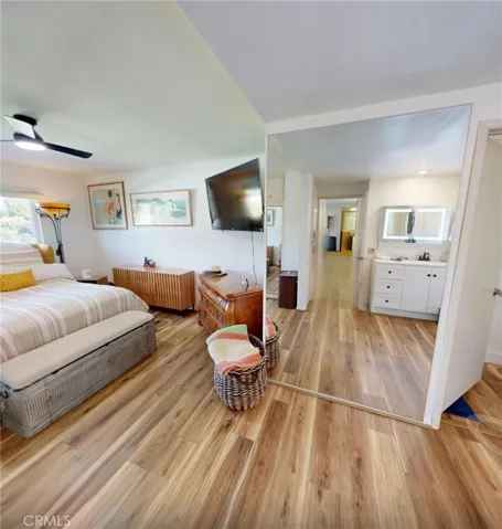 Primary suite dressing area featuring a full wall-length mirror, creating a bright and open space perfect for getting ready, complemented by luxury vinyl flooring and seamless flow throughout.