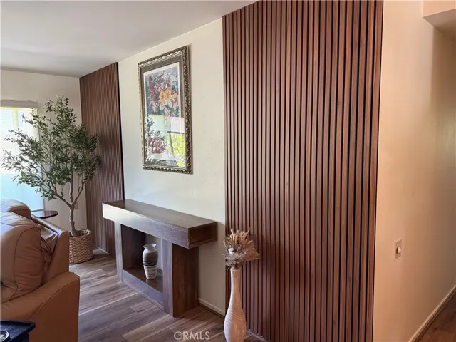 Custom vertical wood slat accent wall creates a warm, modern focal point, adding depth, texture, and architectural interest to the living space.