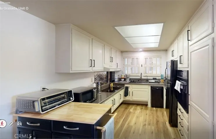 Bright, well-designed kitchen featuring abundant cabinet storage, a convenient pantry, and ample counter space for everyday living and entertaining.
