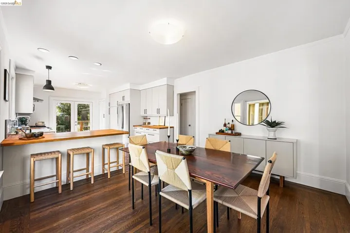 Dining space with dark wood finished floors and baseboards