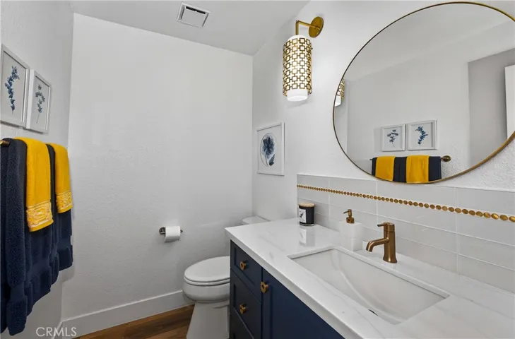Guest bath near garage entry - love these gold accents!