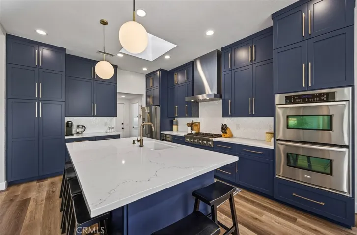 Don't you just love this kitchen!  The blue cabinets with gold hardware sure makes a statement!