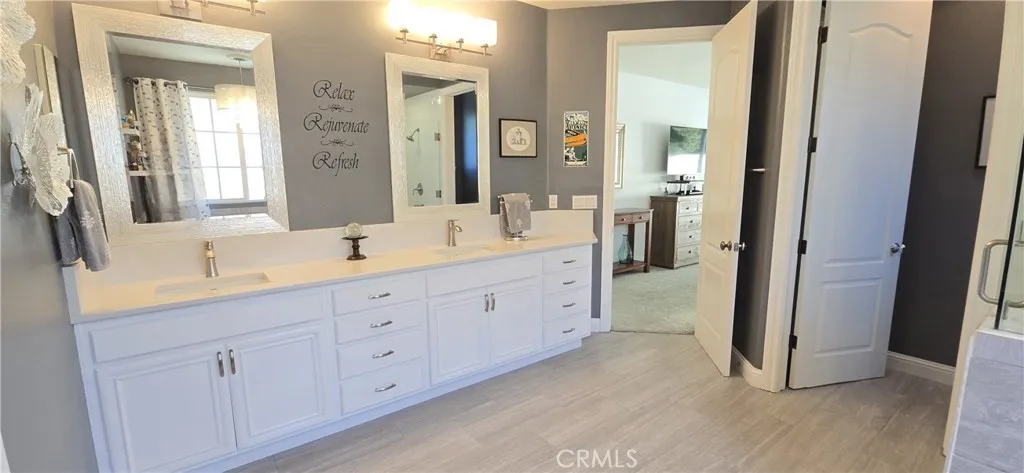 spacious bathroom with 2 sinks & separate toilet room.