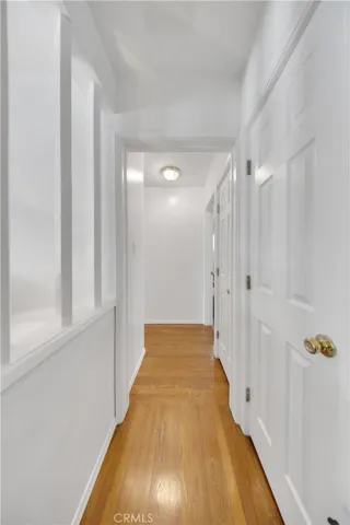 Hallway 2 bedrooms on one side of house and one bedroom and bath on other side .