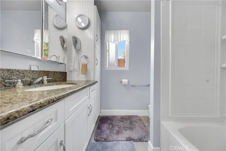 Shower tub combo with storage in On suite bath off Primary bedroom
