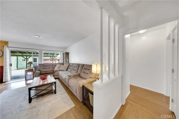 Living Room plus part of hallway- Sliding door and window looks out to the sparkling Pool!