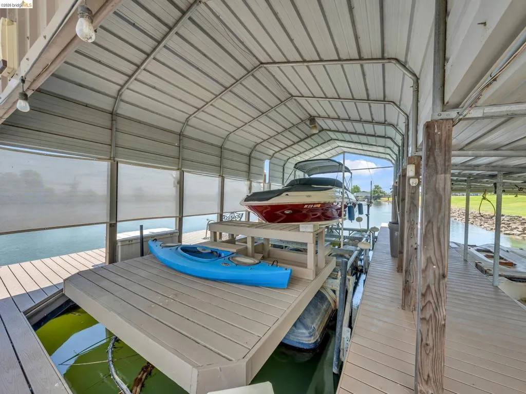 Dock featuring boat lift and a water view