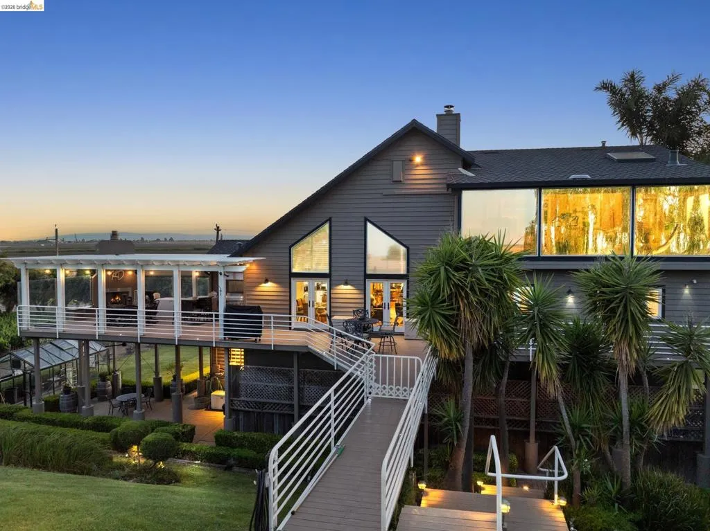 Rear view of property with a wooden deck and a chimney