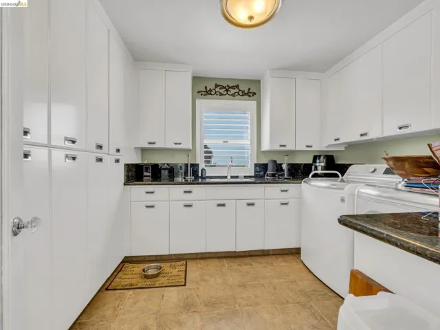Laundry area featuring washing machine and clothes dryer and cabinet space