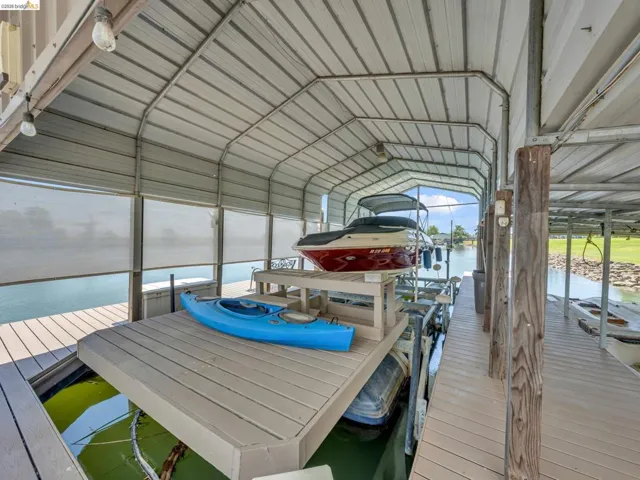 Dock featuring boat lift and a water view