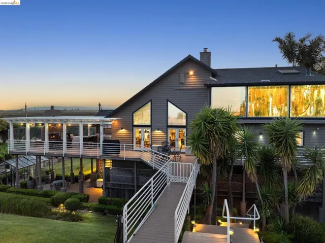 Rear view of property with a wooden deck and a chimney