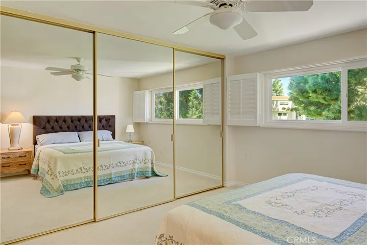 Another view of the Primary Bedroom from the oposite side with mirrored wordrobe