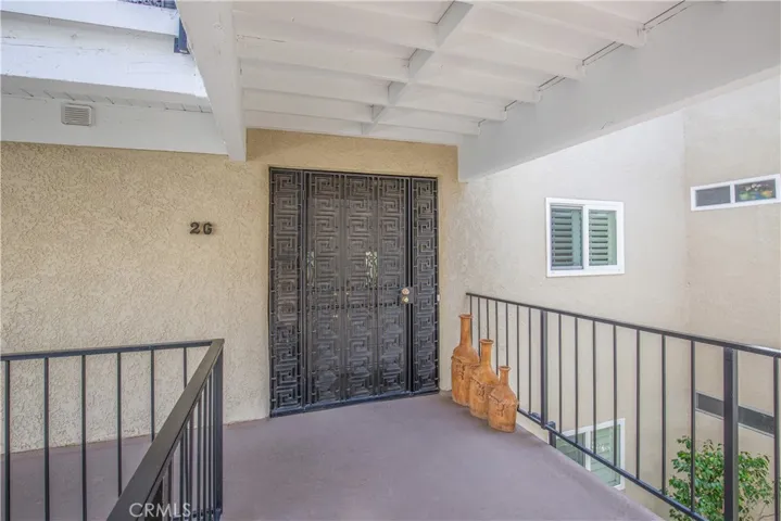 Beautiful Enclosed Private Wrougt Iron Entry Doors.