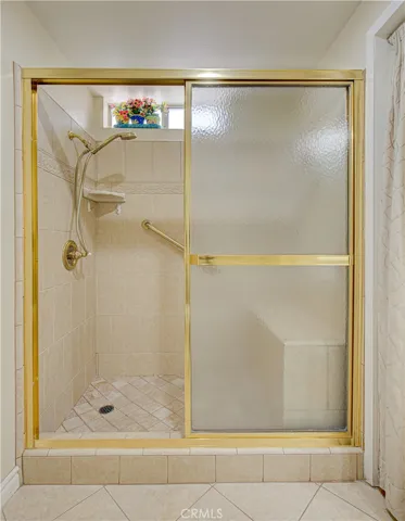 View of the Primary Bathroom Shower. with a built in seating.