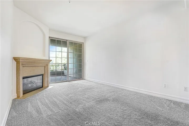 Family room or possible den with fireplace and access to balcony #2.