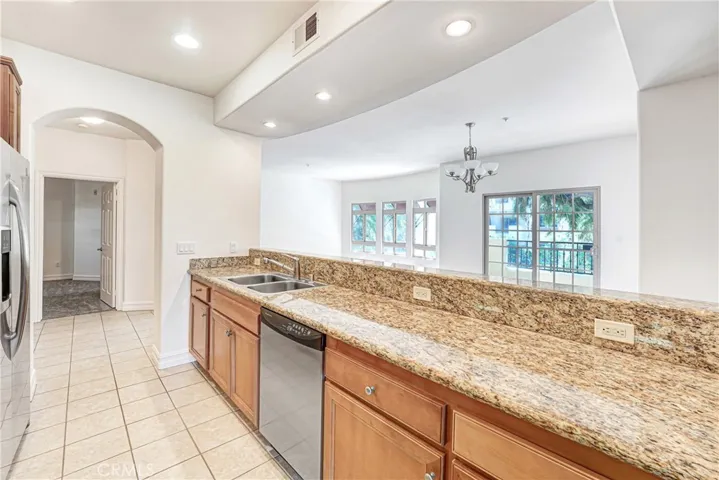 Kitchen with view to living room and dining room.