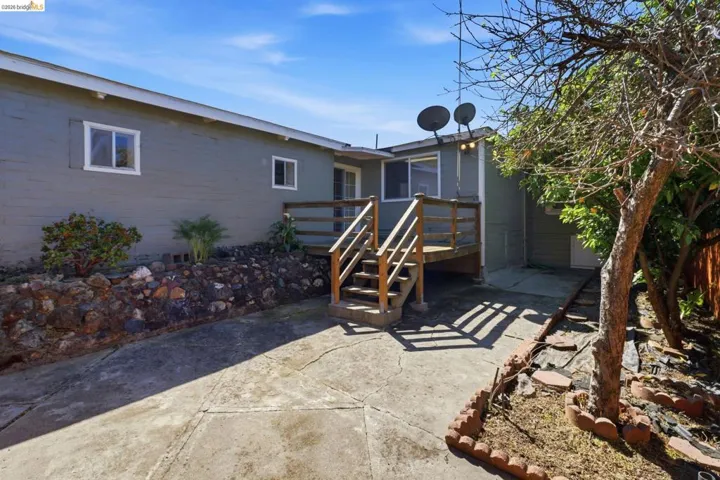 Back of house with a wooden deck and a sunroom