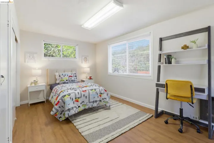 Bedroom featuring light wood-style floors and multiple windows