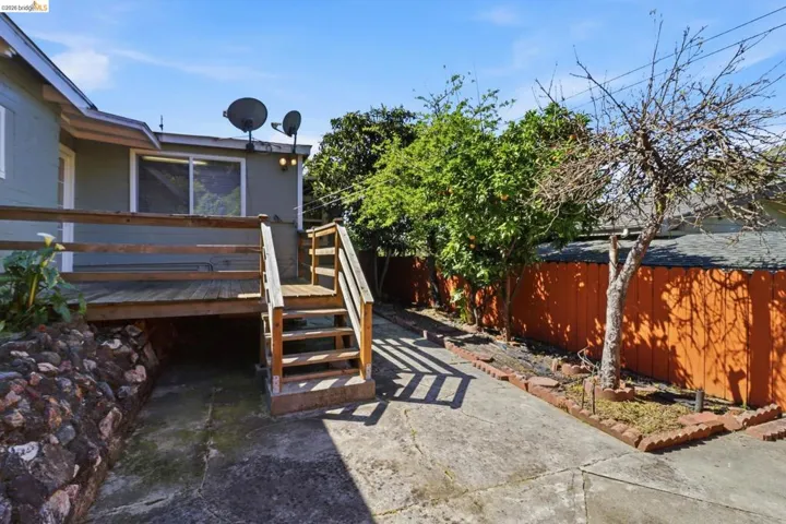 Fenced backyard featuring a deck