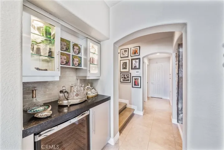 Hall to a Second Downstairs En Suite Bedroom, Powder Room and Garage.