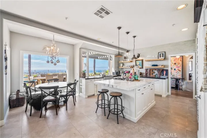 This kitchen rocks with a Statuary Marble island, honed black granite counters and French limestone floors. The view is epic.