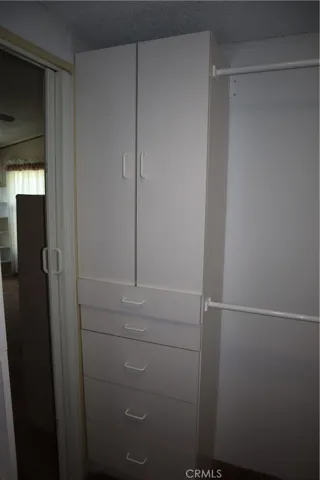Large walk-in closet with built in storage and racks